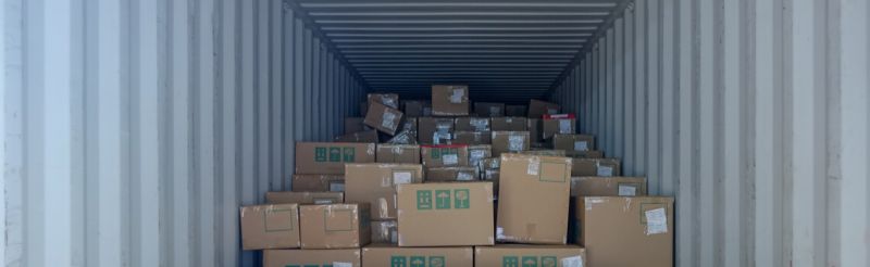 A large storage unit filled with stacked cardboard boxes.