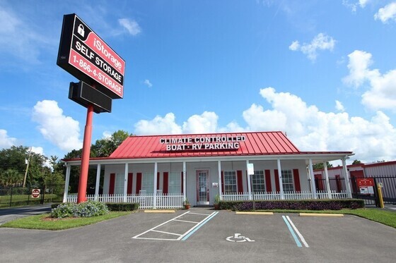An NSA Storage facility with a sign that reads "iStorage Self Storage, 1-866-4-STORAGE" and text on the building that reads "Climate Controlled, Boat, RV Parking."
