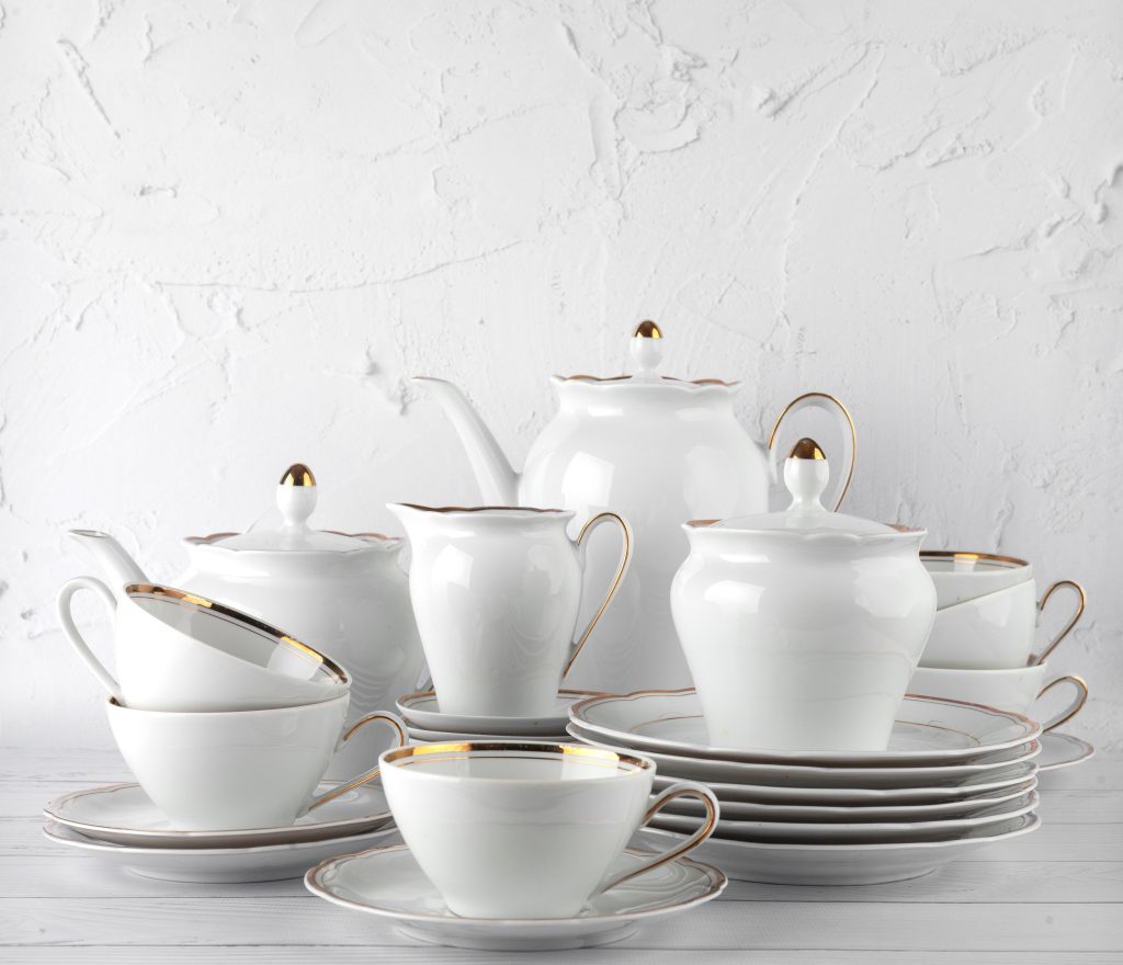 A white china set including plates, teacups, and teapots.