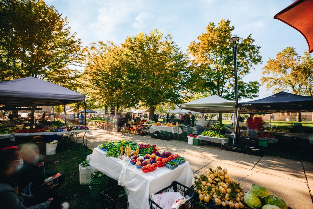 A farmers market full of vendors.