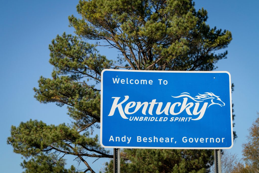 The Kentucky state welcome sign with text: " Welcome to Kentucky- Unbridled Spirit."