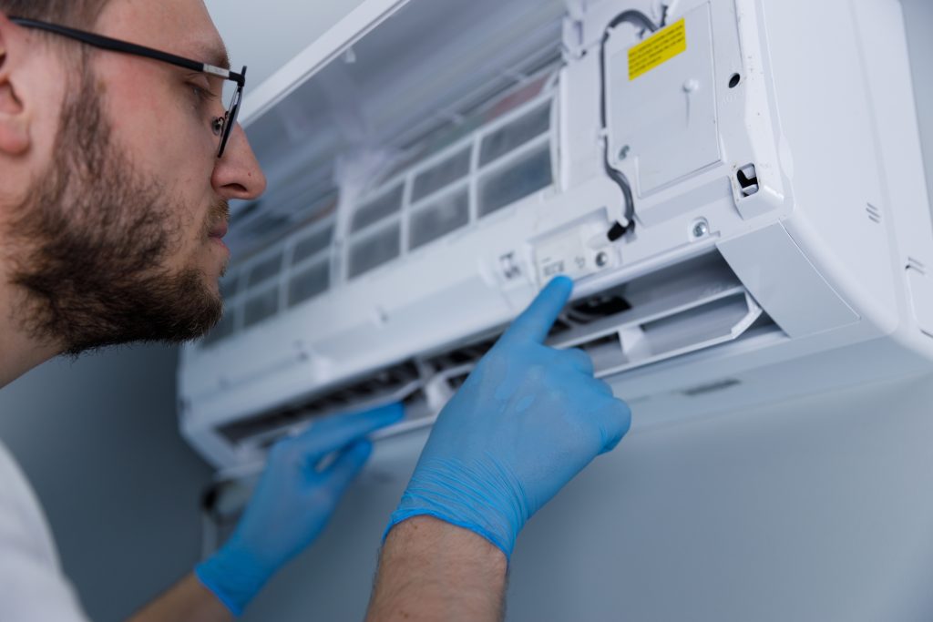 An HVAC technician inspecting a heater.