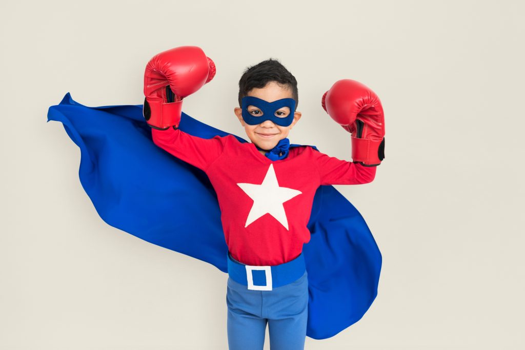 A young boy in a DIY superhero costume.