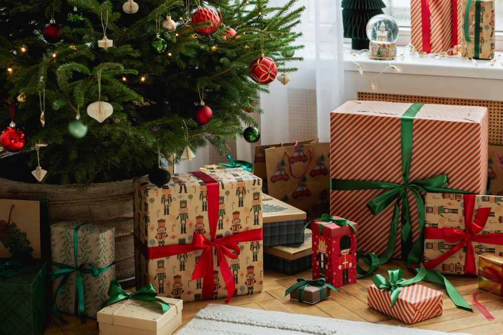 Christmas presents underneath a tree.