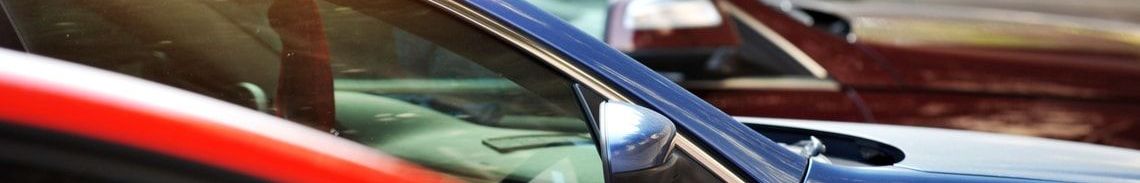 A row of neatly parked cars in a parking lot.